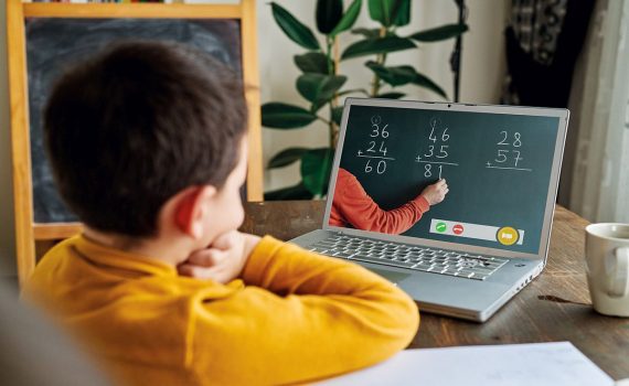 6-7 years cute child learning mathematics from computer.